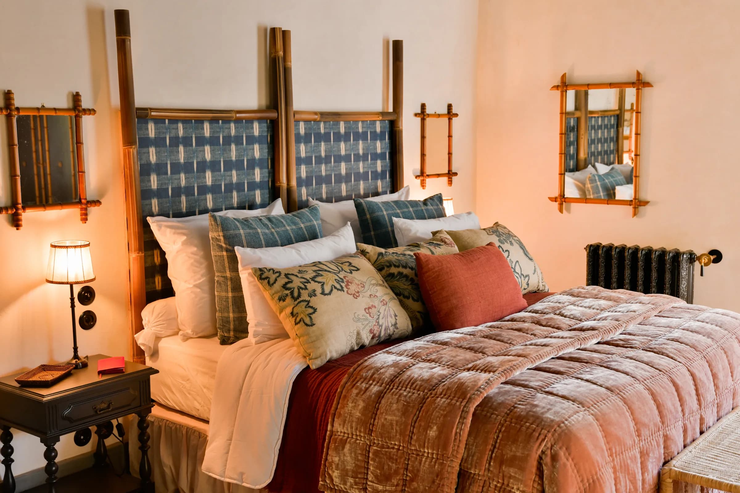 The Dahlia suite — the bamboo four-poster bed dressed in coral and indigo